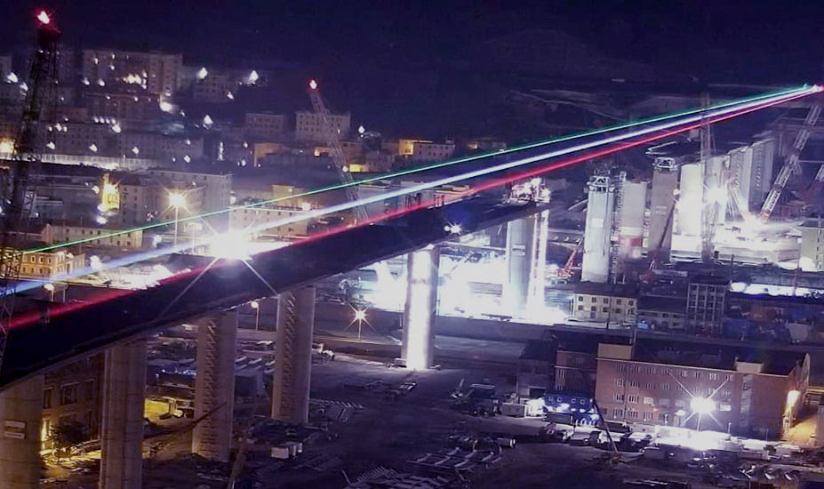 Una luce tricolore a Genova segna il ponte che avanza e lancia un messaggio di fiducia a tutto il paese